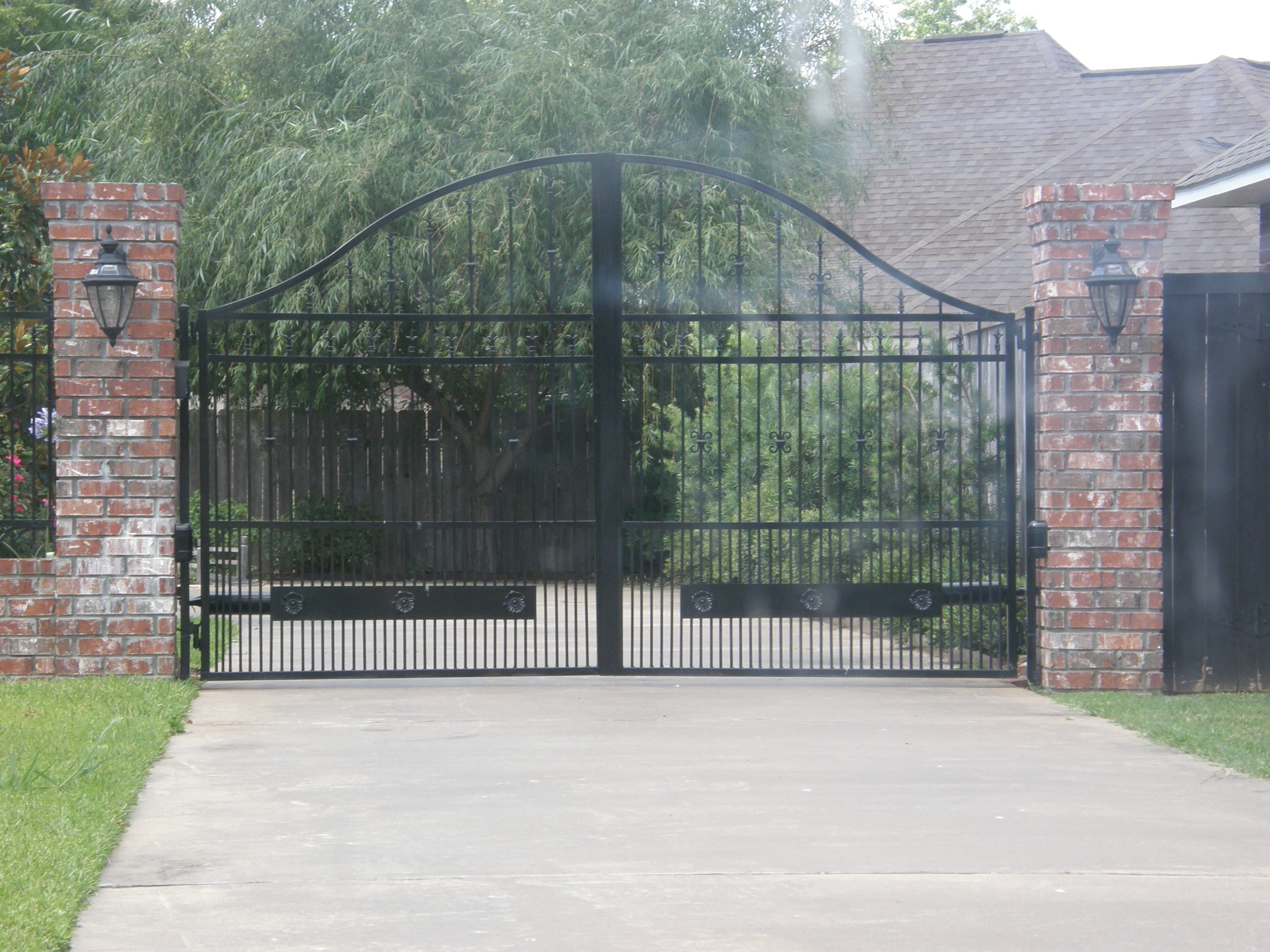 Brick column driveway gate with iron panels
